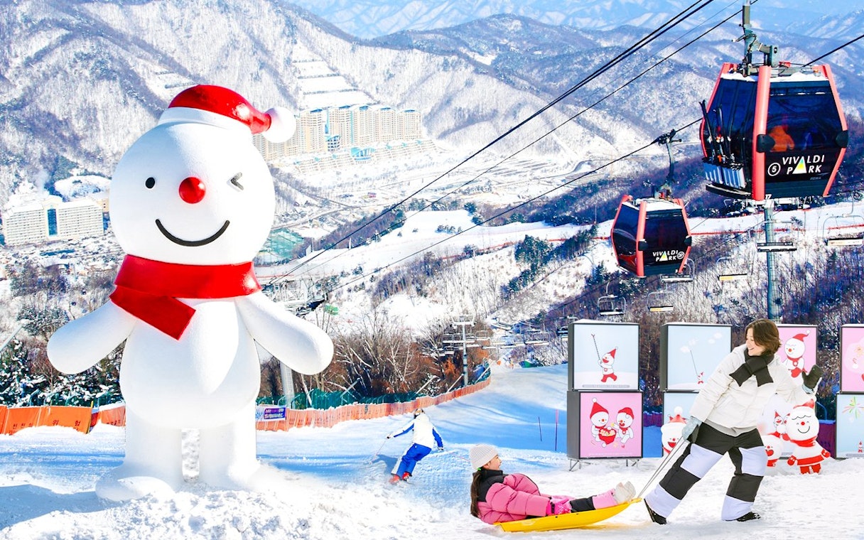 Snowman and ski lift at Vivaldi Park Ski Resort with sledding and skiing activities.