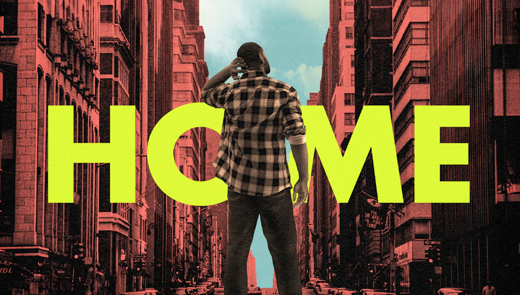 Person standing in a city street with large "HOME" text in the background.