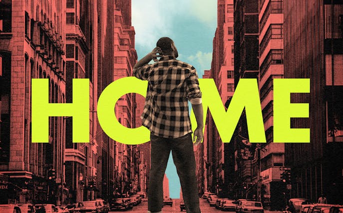Person standing in a city street with large "HOME" text in the background.