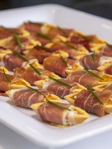 Prosciutto-wrapped appetizers on a platter, served on the London Dinner Cruise.