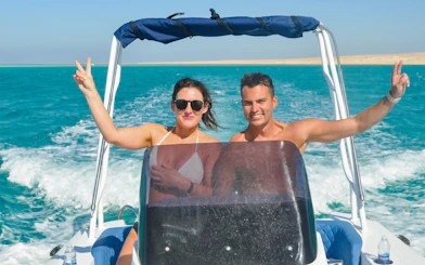 High-speed sea taxi on turquoise waters to Orange Bay or Magawish.