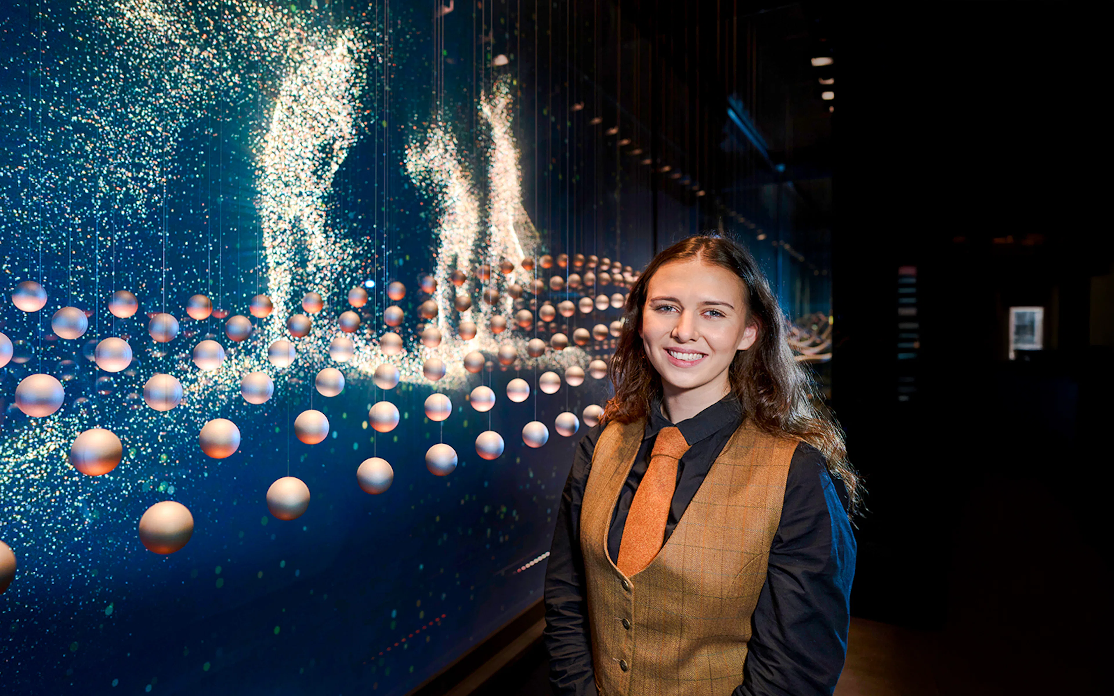Guide at the Scotch Whisky Experience tour with interactive display in background.