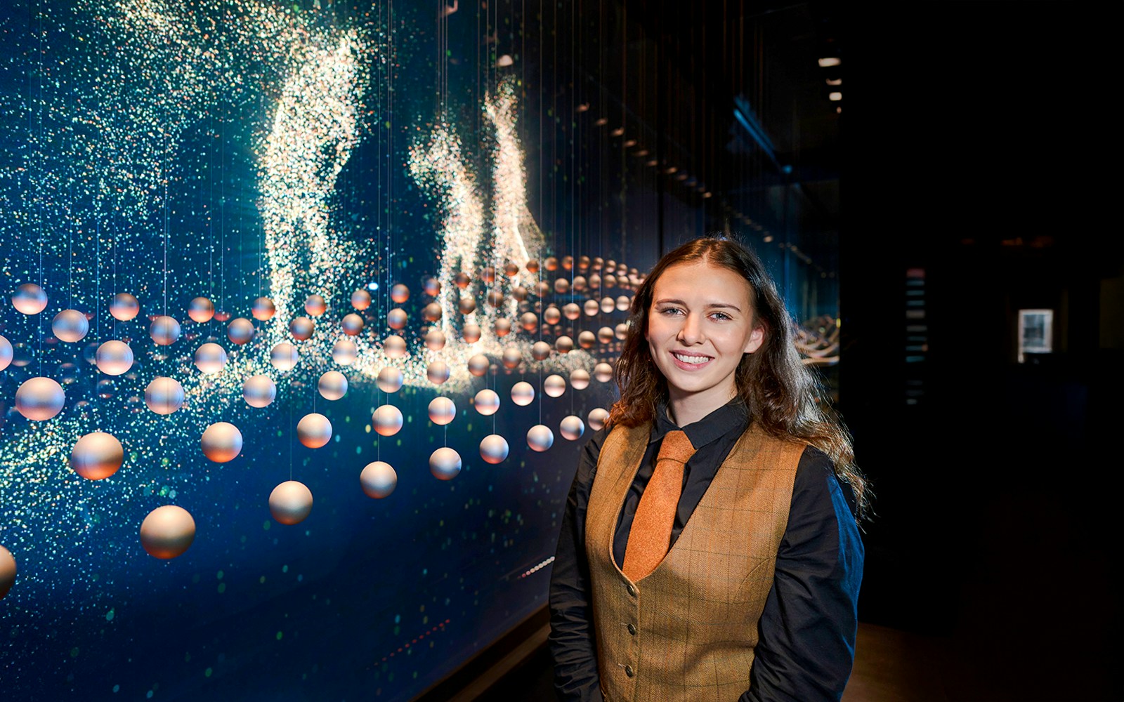 Guide at the Scotch Whisky Experience tour with interactive display in background.