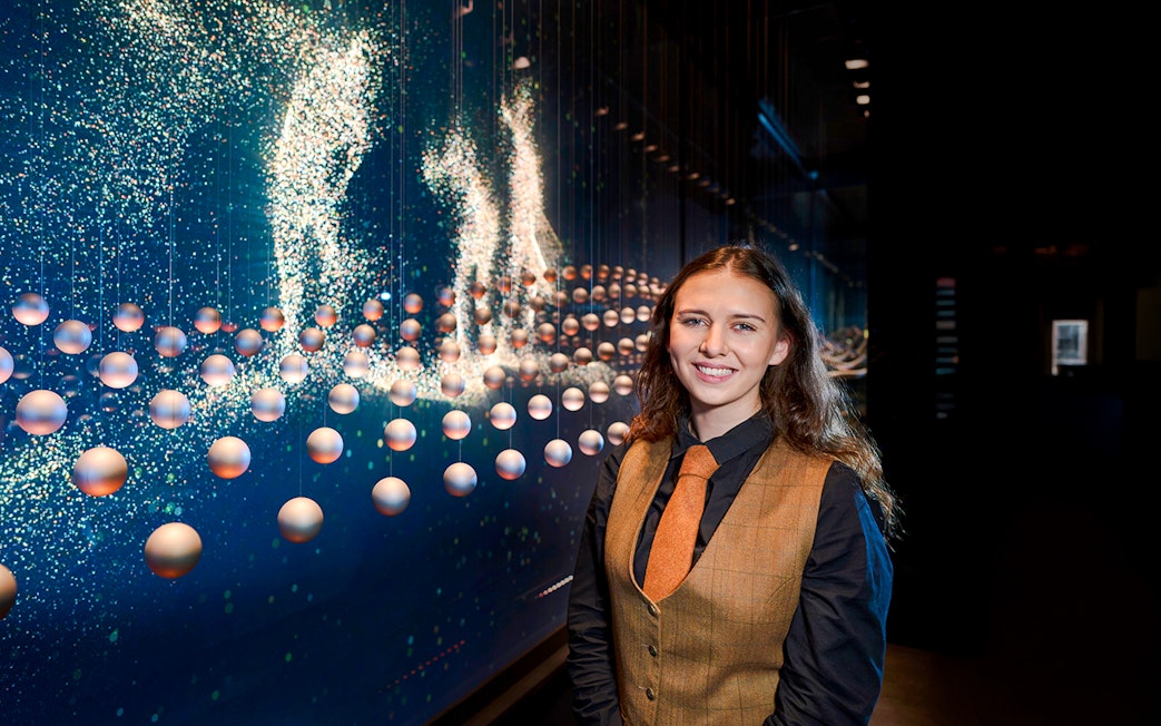 Guide at the Scotch Whisky Experience tour with interactive display in background.