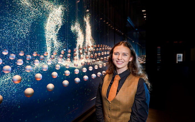 Guide at the Scotch Whisky Experience tour with interactive display in background.