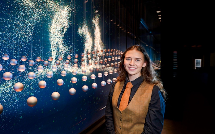 Guide at the Scotch Whisky Experience tour with interactive display in background.
