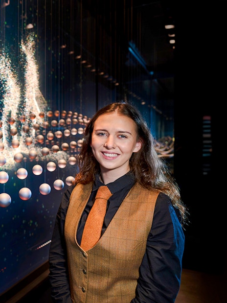 Guide at the Scotch Whisky Experience tour with interactive display in background.