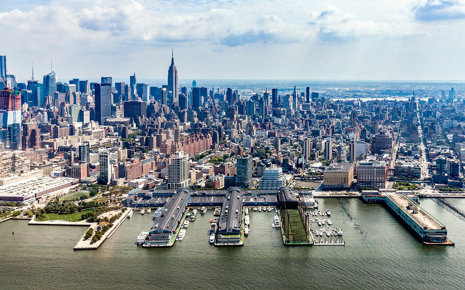 Aerial view of Chelsea Piers and Manhattan skyline from a helicopter in New York City.