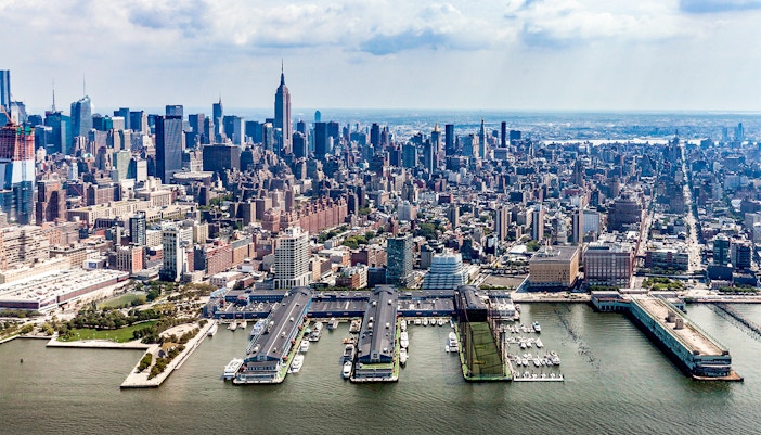 Aerial view of Chelsea Piers and Manhattan skyline from a helicopter in New York City.