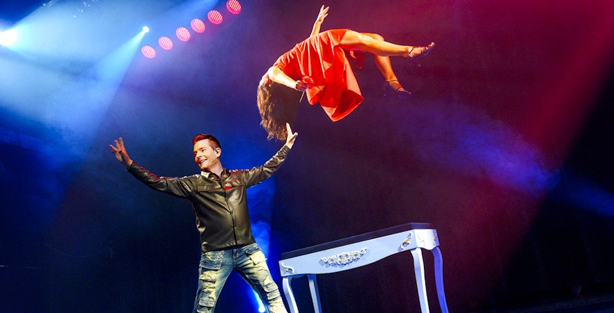 Magician performing levitation trick at The Wild Magic Show, Greg Frewin Theatre.