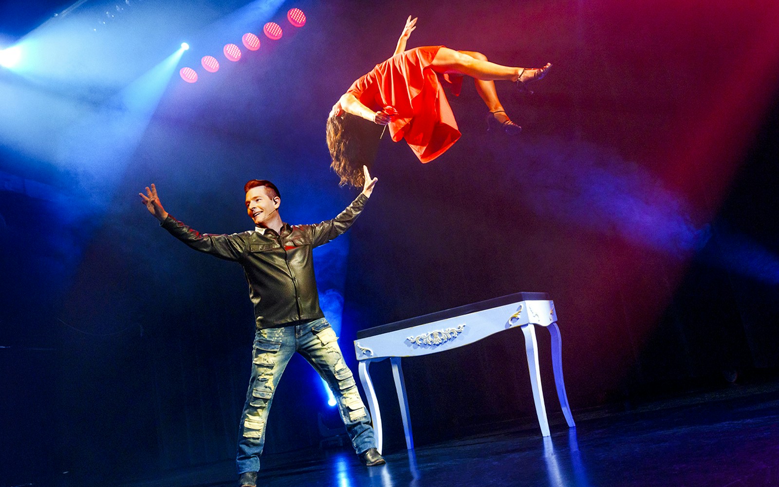 Magician performing levitation trick at The Wild Magic Show, Greg Frewin Theatre.