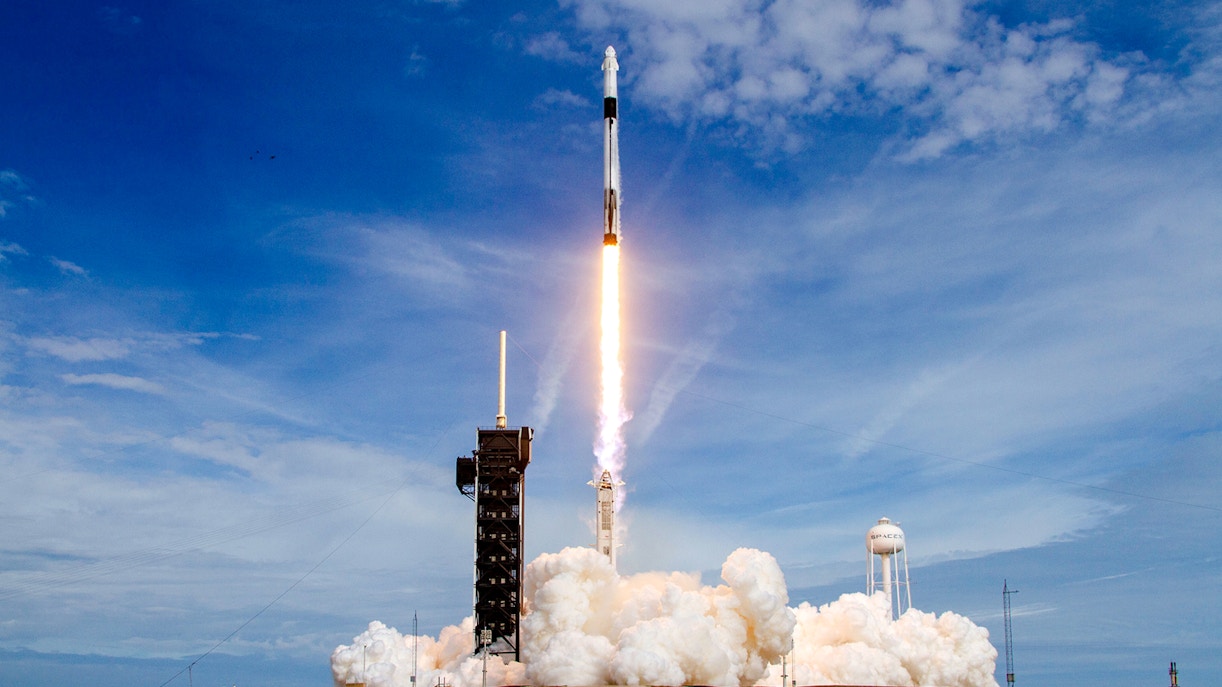SpaceX Falcon 9 rocket launching at Cape Canaveral, Florida, with fiery exhaust trail.