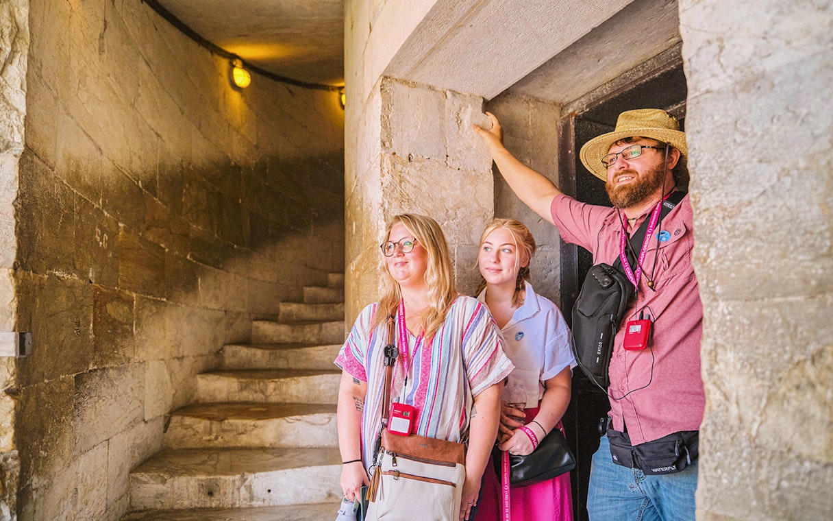 Guests exploring the interior staircase of the Leaning Tower of Pisa.