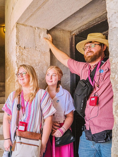 Guests exploring the interior staircase of the Leaning Tower of Pisa.