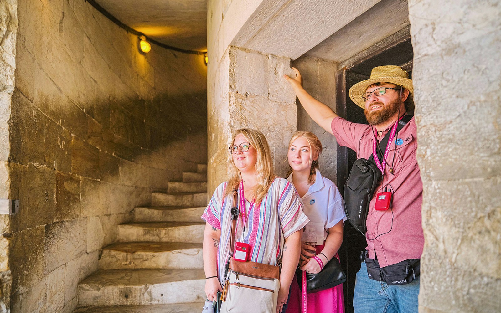 Visitors exploring the interior spiral staircase of the Leaning Tower of Pisa, Italy.