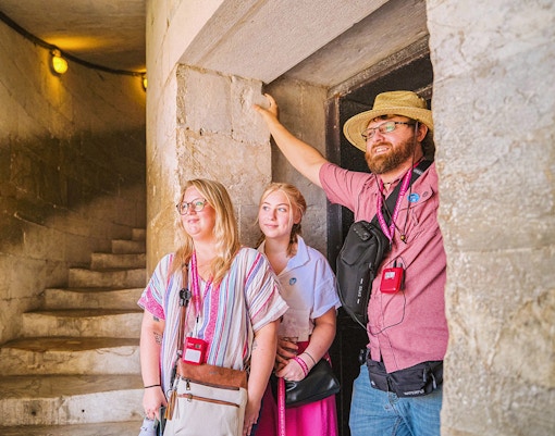 Guests exploring the interior staircase of the Leaning Tower of Pisa.