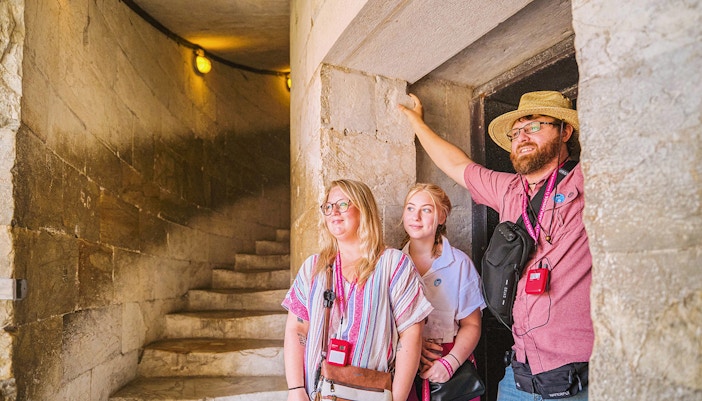 Guests exploring the interior staircase of the Leaning Tower of Pisa.