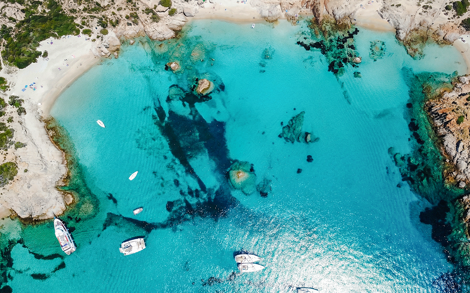 Sailing boats in turquoise waters of La Maddalena Archipelago, Sardinia.