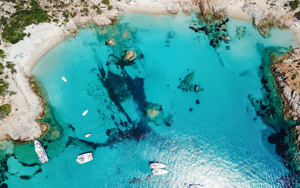 Sailing boats in turquoise waters of La Maddalena Archipelago, Sardinia.