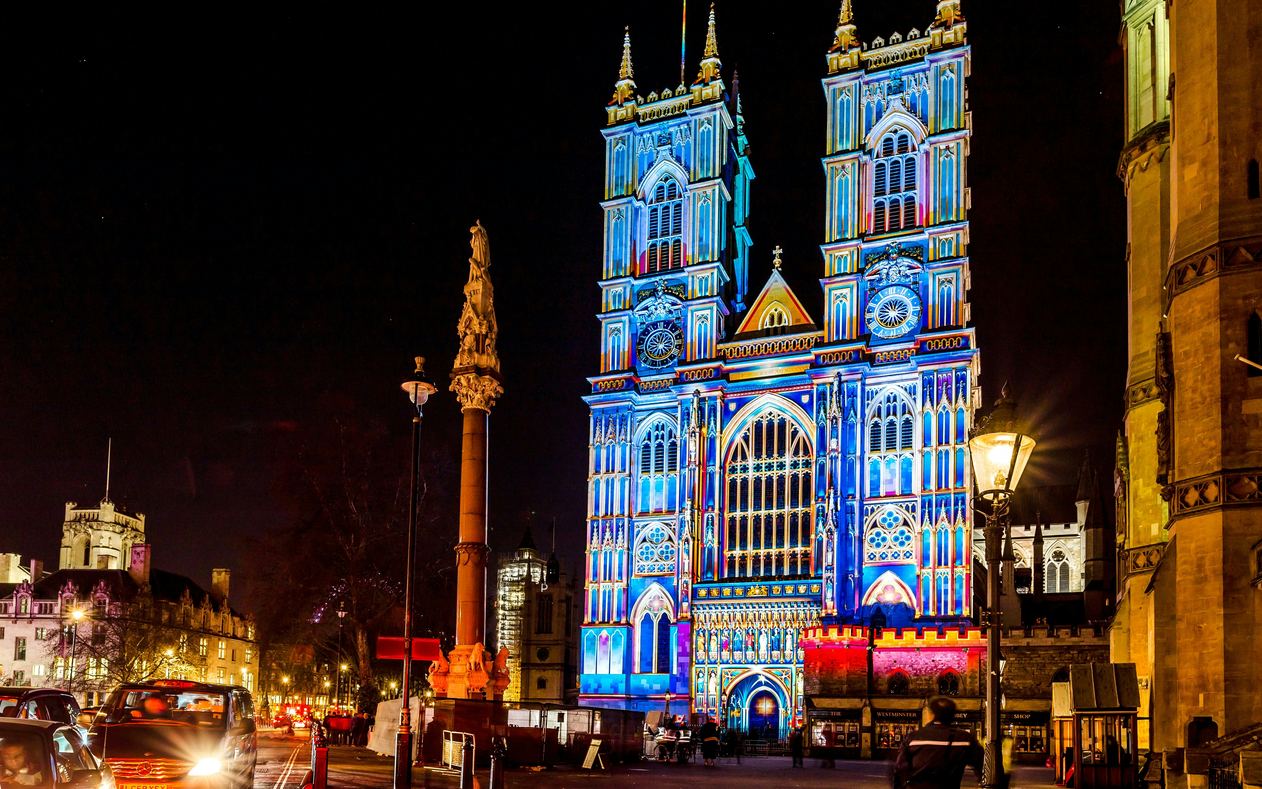Illuminated Westminster Abbey with colorful lights during Christmas in London.
