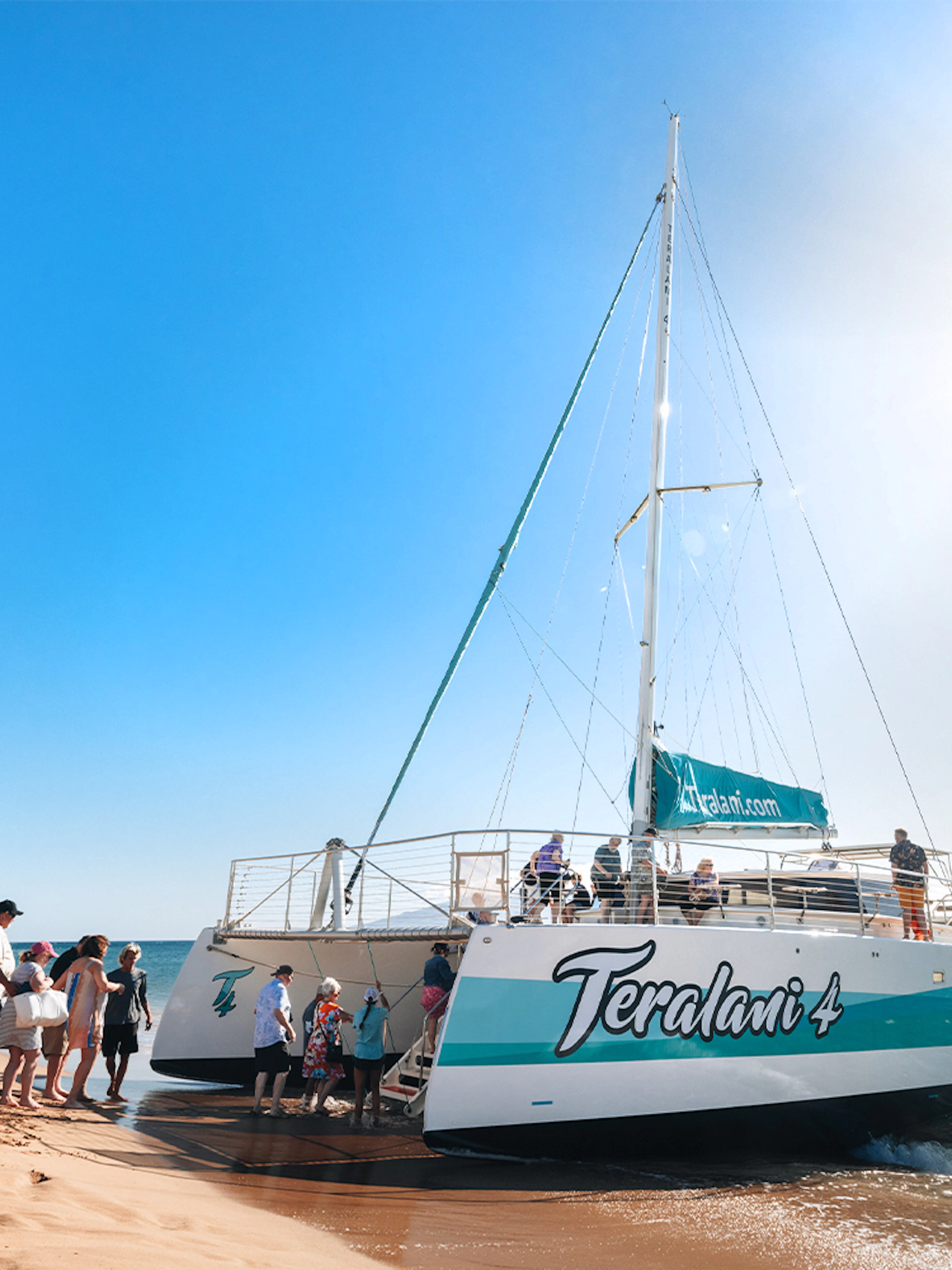 Boarding a catamaran for a whale watching tour at Kaʻanapali Beach, Maui, Hawaii.