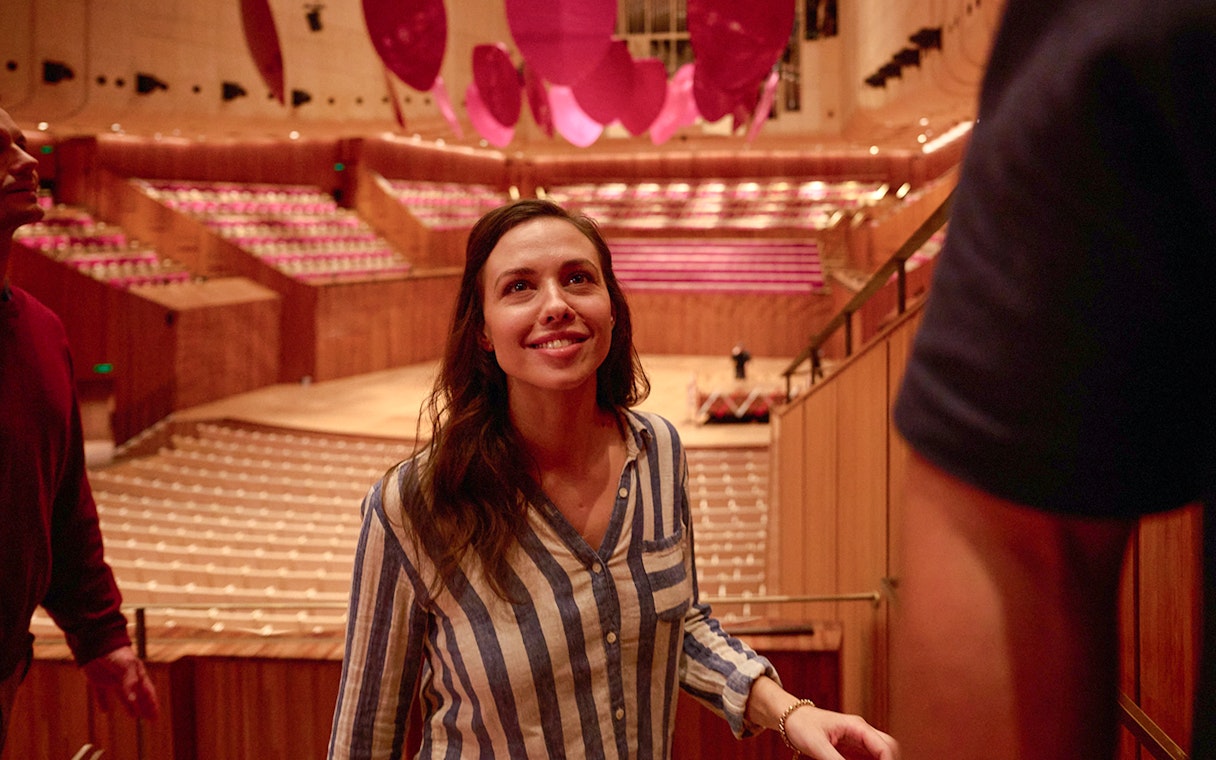 Visitor exploring the interior of Sydney Opera House during a guided walking tour.