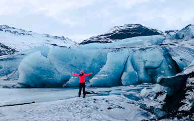 Guests exploring Solheimajokull glacier in Iceland with icy landscape.