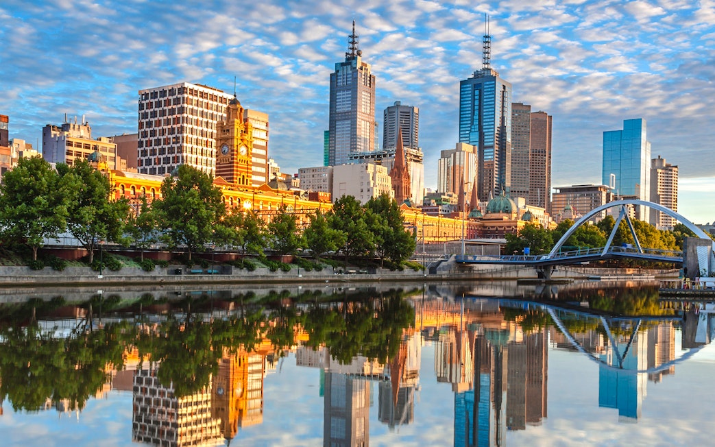 Melbourne skyline reflected in Yarra River during a river cruise.