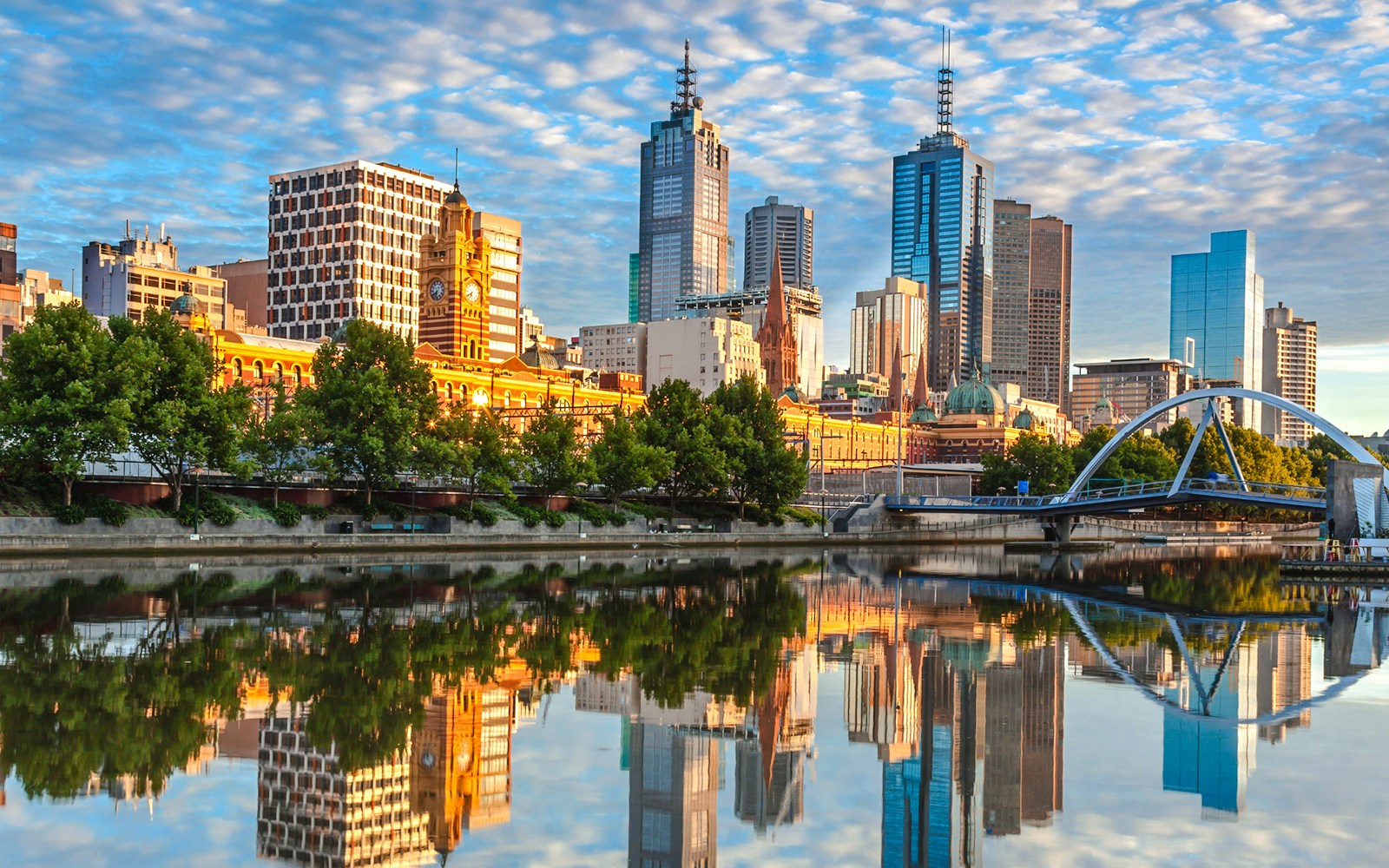 Melbourne skyline reflected in Yarra River during a river cruise.