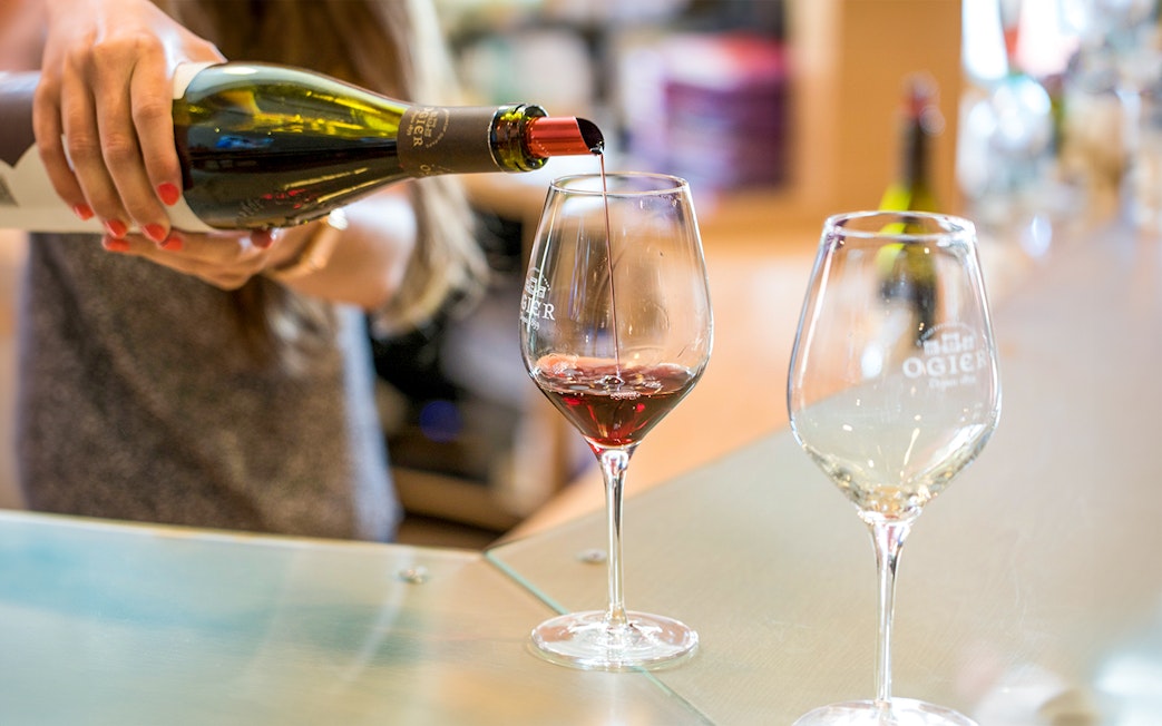 Wine tasting in Provence with red wine being poured into a glass.