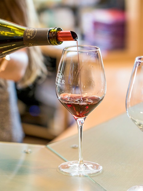 Wine tasting in Provence with red wine being poured into a glass.