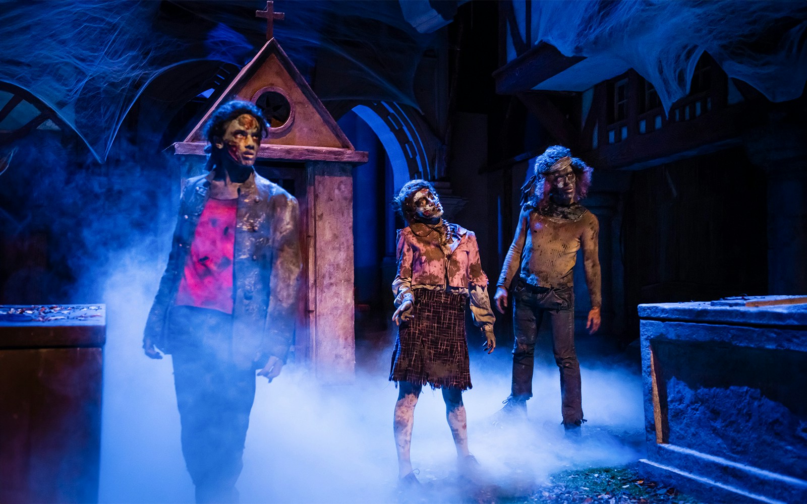 Zombies in foggy graveyard scene