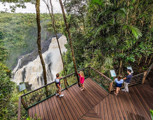 Visitors at Barron Falls lookout near Skyrail station, surrounded by lush rainforest.
