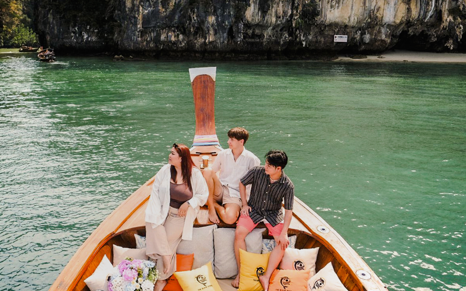 Tourists on a luxury longtail boat in Krabi, Thailand, near Koh Hong cliffs.