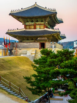 Traditional Korean pavilion at Korean Folk Village with surrounding greenery.
