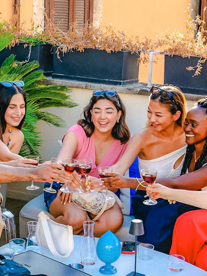 Group enjoying drinks on a rooftop during the Tipsy Tour in Rome.