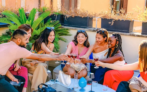 People enjoying a wine tasting experience during the Tipsy Tour in Rome, Italy.