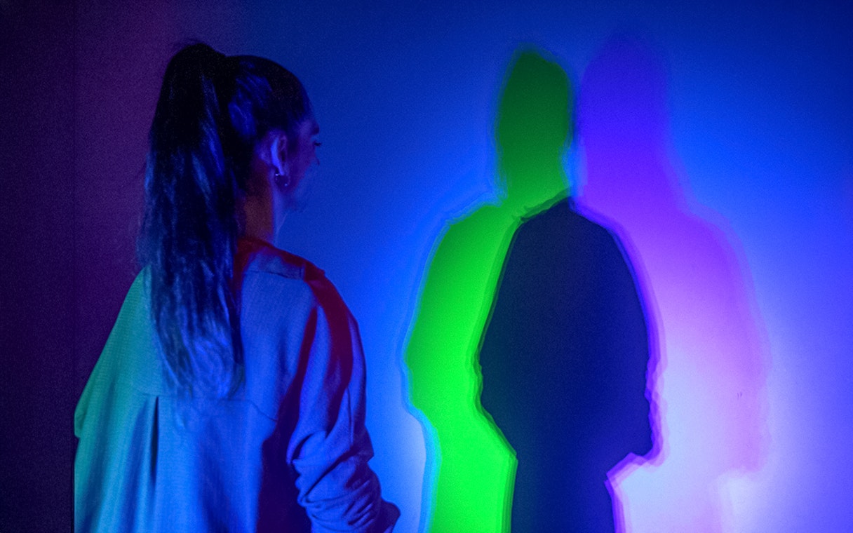 Guest interacting with colorful light display at Istanbul Digital Experience Museum.