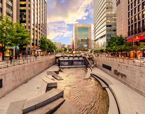 Cheonggyecheon Stream in Seoul with people walking along the promenade.