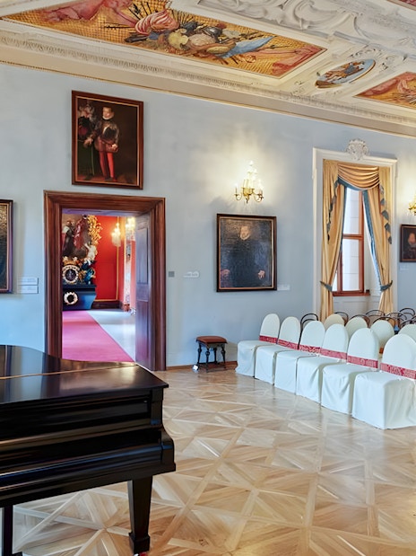 Lobkowicz Palace concert room with grand piano and arranged seating.