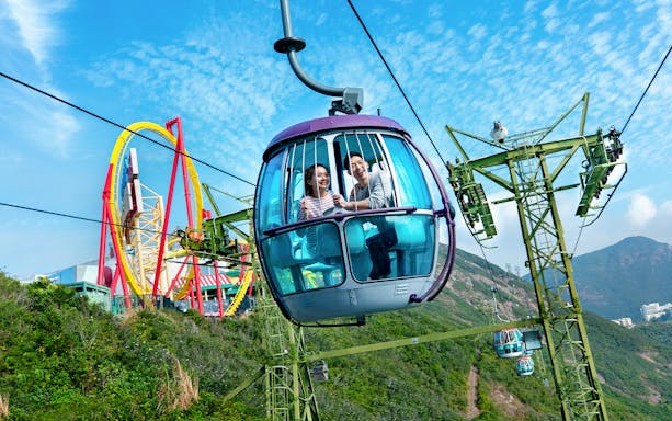 Cable car ride at Ocean Park Theme Park with roller coaster in the background.