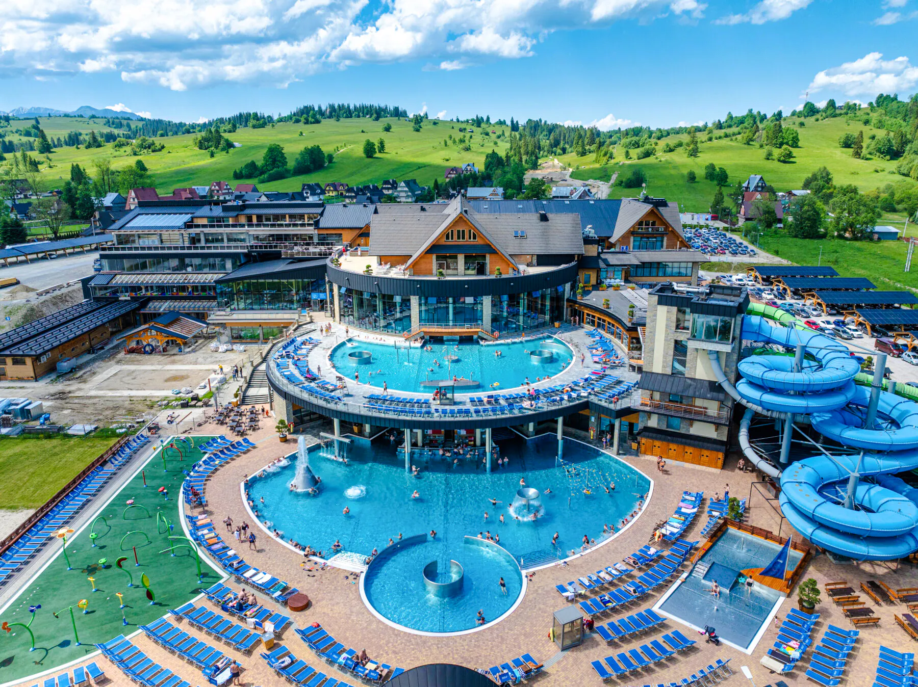 Zakopane hot springs complex with pools and water slides, view from Krakow day trip.