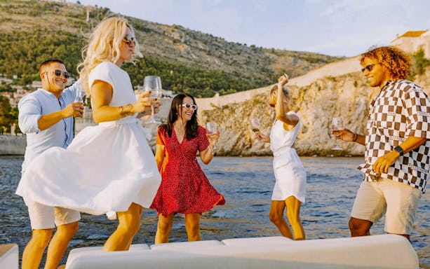 Guests enjoying drinks on a private sunset cruise in Dubrovnik.