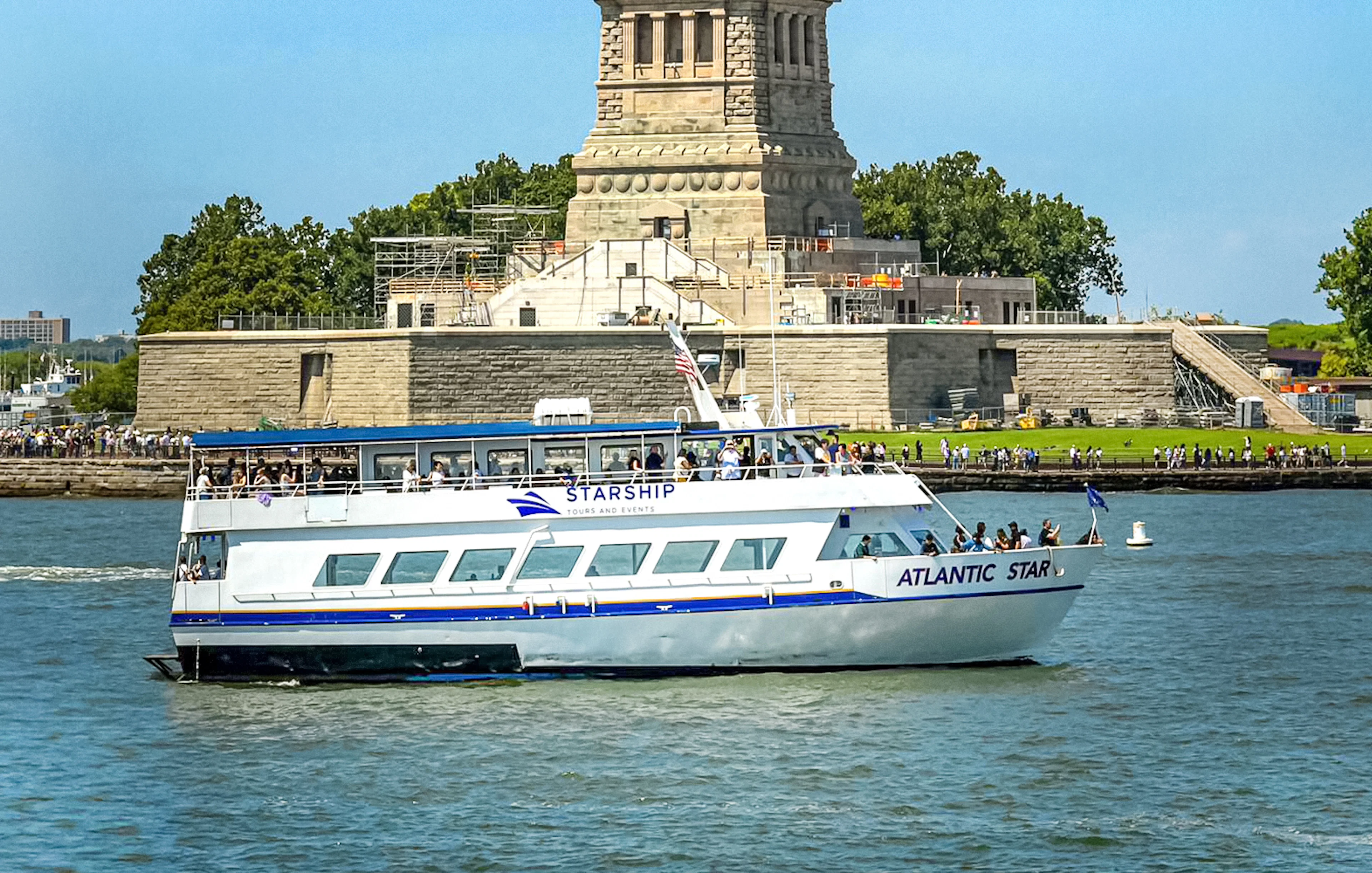 Cruise boat near Statue of Liberty on East River tour.