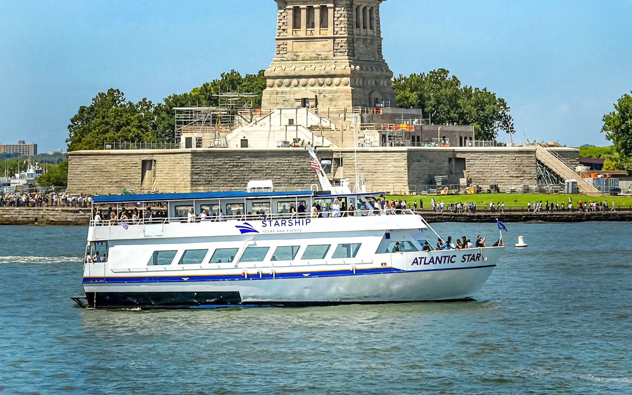 Cruise boat near Statue of Liberty on East River tour.