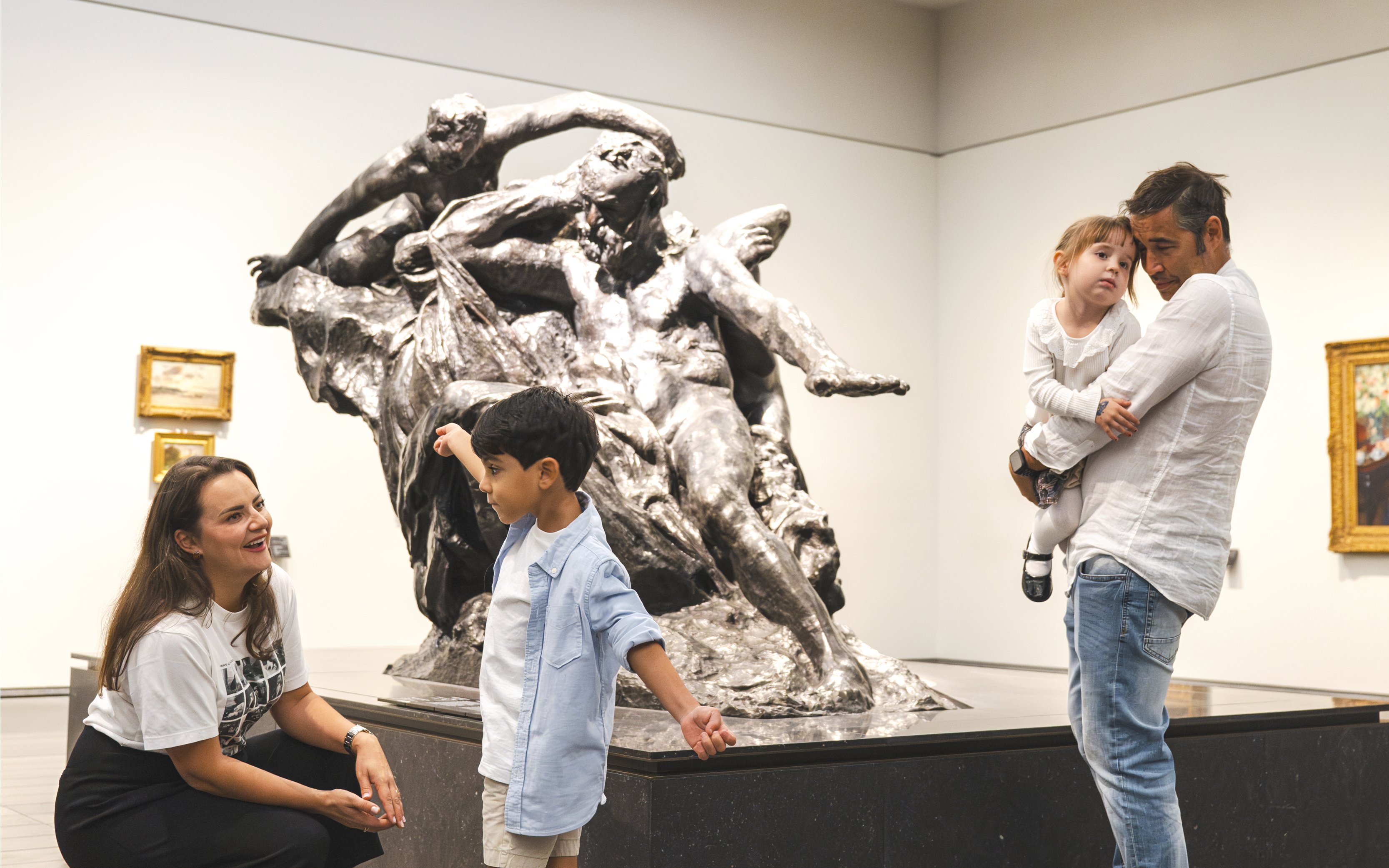 Family exploring sculpture at Louvre Abu Dhabi.