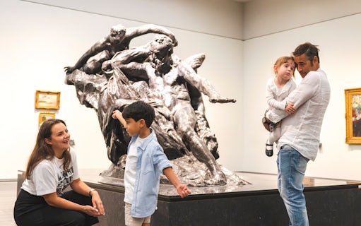 Family exploring sculpture at Louvre Abu Dhabi.