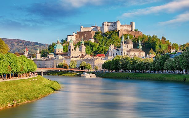 Fortress Hohensalzburg overlooking Salzburg with river and historic buildings.