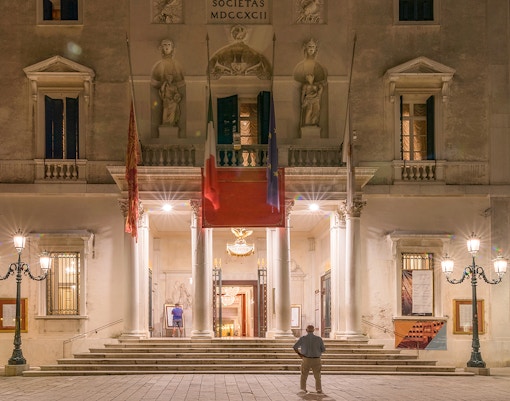 Night view of the facade of the famous Gran Teatro La Fenice theater, San Marco district, Venice, Italy