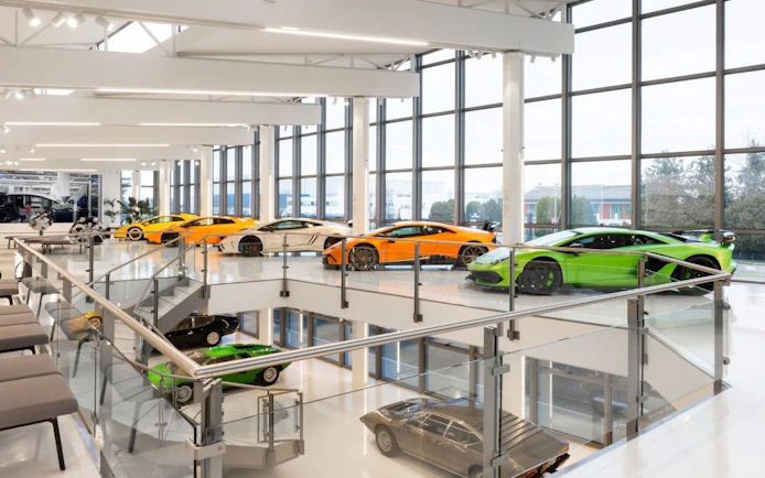 Lamborghini supercars display, featuring Miura and Countach models in a modern showroom.
